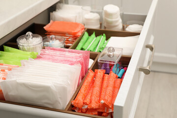 Fototapeta na wymiar Storage of different feminine hygiene products in drawer indoors, closeup