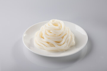 Fresh Japanese noodles,Boiled Japanese udon noodles,Japanese food, in white plate on white background.