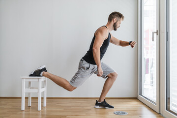 Handsome man working out at home