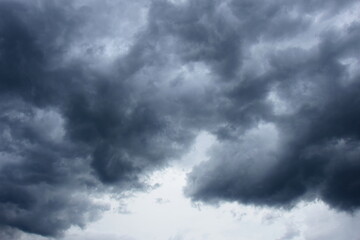 Dark grey threatening thunderclouds, rain clouds in the dark sky, weather change, summer thunderstorms, thunderclouds and rain clouds dark and grey, grey sky
