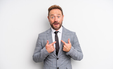 middle age handsome man feeling happy and pointing to self with an excited. businessman concept