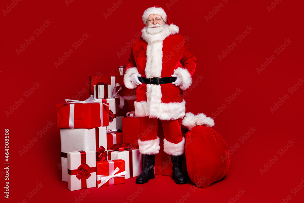 Wall mural photo of cheerful handsome retired man wear santa claus costume spectacles smiling preparing present