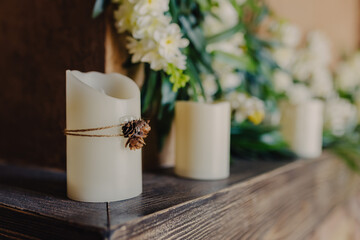 Cosy autumn interior decoration. Candels on the fireplace.