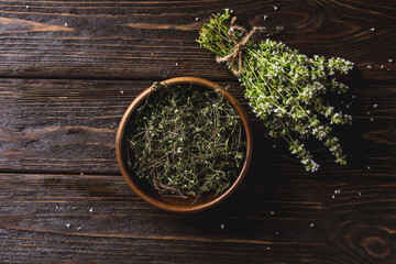 Fresh and dry thyme on a wooden background. Harvesting of medicinal herbs. Alternative medicine