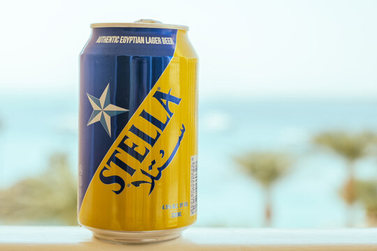 Metal can of Stella beer against the background of the sea and palm trees