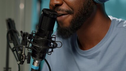 Close up of vlogger using microphone for online podcast on social media. Blogger talking to subscribers with modern equipment and tools for vlog channel on video. Man with gear