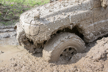 Car wheel stuck in mud, motorsport, mud tire testing. Off-road driving, car breakdown. Emergency...