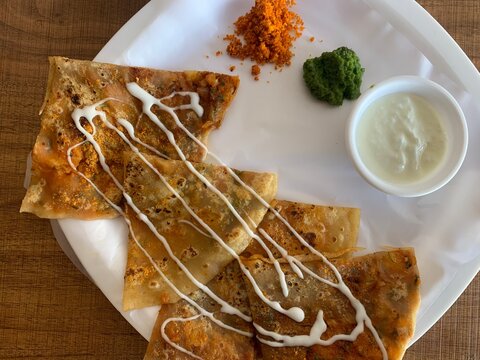Aloo Paratha or Indian Potato stuffed Flatbread. Served with fresh curd and chutneys. selective focus
