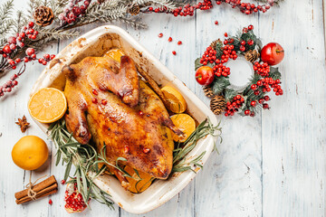 Baked duck with oranges served with on wooden background. Christmas festive table. banner, menu,...