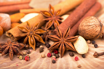 Traditional Christmas spices - Star anise with cinnamon and cloves on dark rustic wooden background