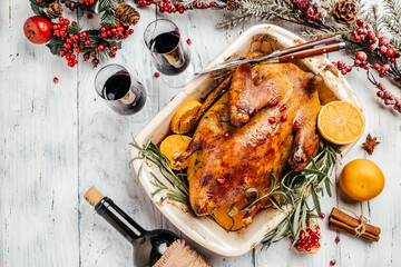 Roast duck with orange rosemary, and berries served on a festive table. Dish for Christmas Eve....