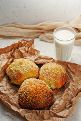 Homemade cinnamon buns and a glass of cow's milk. Organic village health food. Copy space for text, free place.