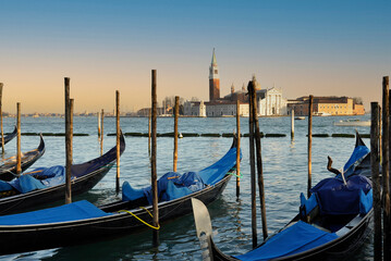Obraz na płótnie Canvas Venice gondola moored with the San Marco Maggiore church in the background
