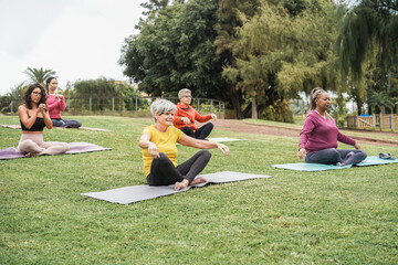 Multi generational people doing yoga class at city park - Focus on center woman face