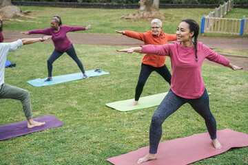 Multi generational people doing yoga class at city park - Focus on african girl face