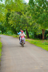 Fototapeta premium Indian agronomist going agriculture field with farmer on bike.
