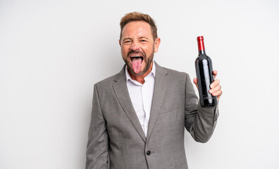 middle age handsome man with cheerful and rebellious attitude, joking and sticking tongue out. wine...