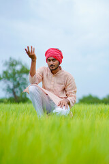 Young indian farmer at green onion agriculture field.