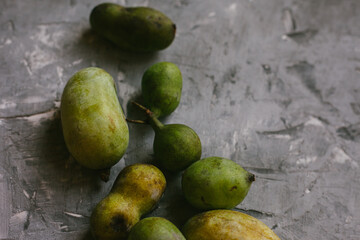 Fresh PawPaw Fruit Arranged On a Gray Textured Background