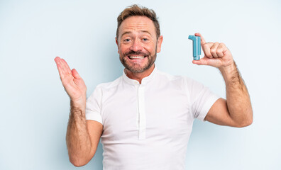 middle age handsome man feeling happy and astonished at something unbelievable. asthma concept