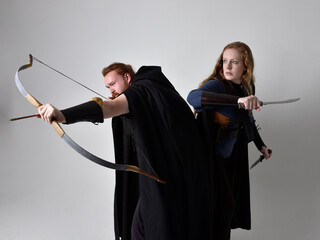 Full length  portrait of red haired  couple, man and woman wearing medieval viking inspired fantasy...
