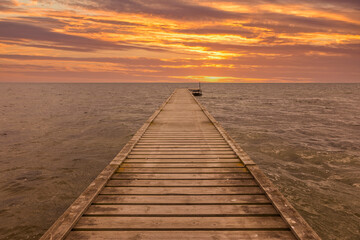 Fototapeta na wymiar Wooden jetty at the Danish Baltic Sea coast in sunset