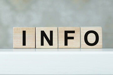 Wooden cubes with the text INFO on on a light background on the table