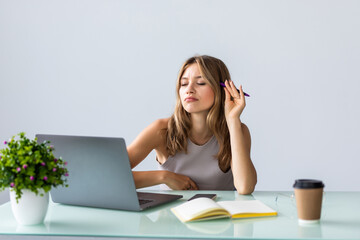 Business woman using laptop computer and sitting by the table in office