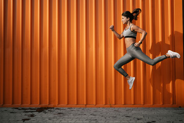 Beautiful athlete woman in sportswear. Young woman training outdoors.  Healthy lifestyle..