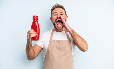 middle age handsome man feeling happy,giving a big shout out with hands next to mouth. ketchup concept