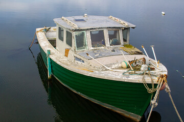 An old dilapidated marine ply cruiser with an inboard diesal eng © Michael