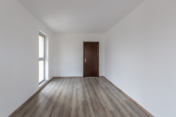 Fototapeta na wymiar Empty room with natural light from windows.Modern house interior. New home. Wooden floor.