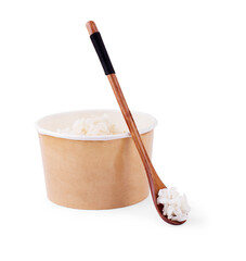 White long prepared rice in the ppper box for take out on white wooden background, top-view flat lay