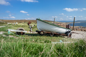 Fishing boat on a rusty trailer by the ocean