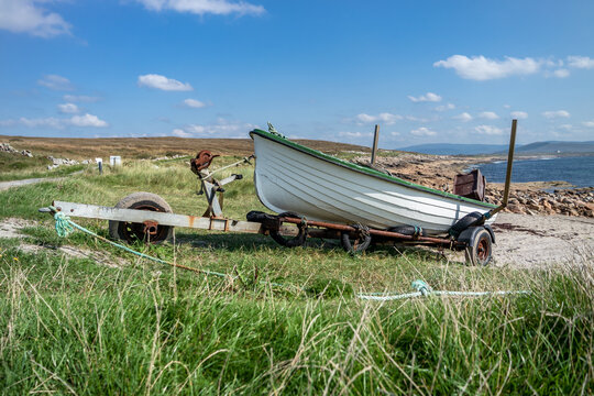 Fishing boat on a rusty trailer by the ocean