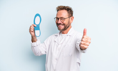 middle age handsome man feeling proud,smiling positively with thumbs up.  podiatrist concept
