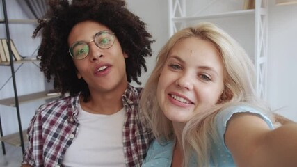 Couple vlog. Live streaming. Social media content. Excited cheerful multiracial influencers waving hi sharing experience recording selfie video blog together in home studio interior.