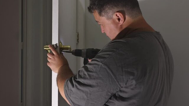 Builder is installing lock a doot in the room installation into wood door
