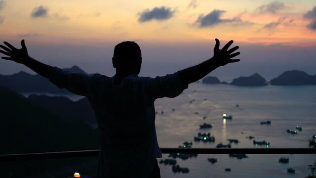 Excited successful man at Ha Long Bay in Vietnam, slow motion