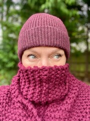 scarf and hat winter wrap up season with mid aged woman eyes showing in woods and trees