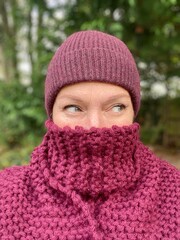 scarf and hat winter wrap up season with mid aged woman eyes showing in woods and trees
