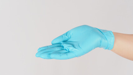 Empty hand palm wearing medical glove isolated on white background.