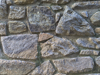 Stone wall. The masonry was made using mortar. Photo taken in Lloret de Mar. Background. Textures.