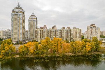 Fototapeta premium Aerial view of the city by the river in autumn