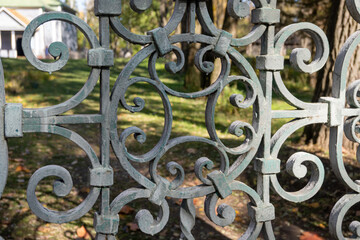 wrought iron gate to the estate with a floral pattern