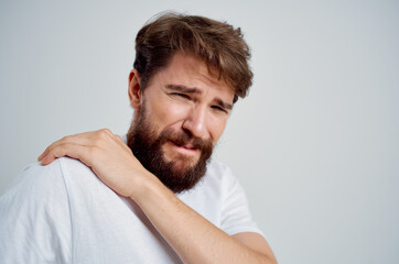Obraz premium man holding neck arthritis health problems light background
