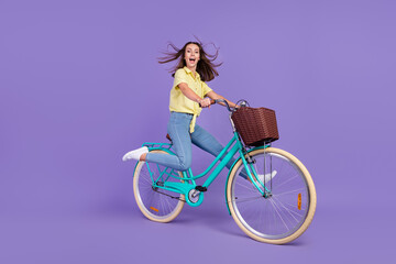 Full size profile photo of impressed young brunette lady go bicycle have fun wear yellow top jeans...