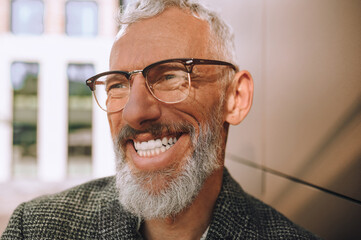 Cheerful man in spectacles gazing into the distance