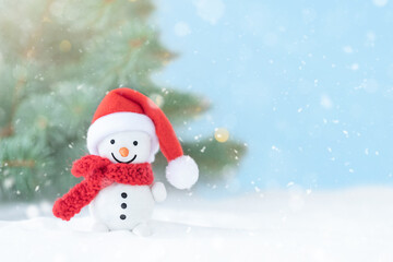 Christmas winter background with snowman in front of Christmas tree