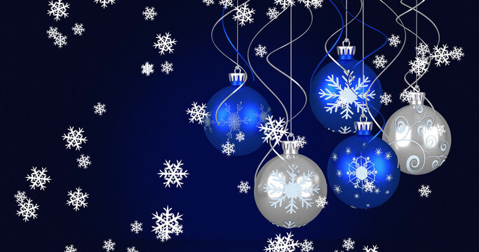 Image of baubles and snow falling on dark blue background